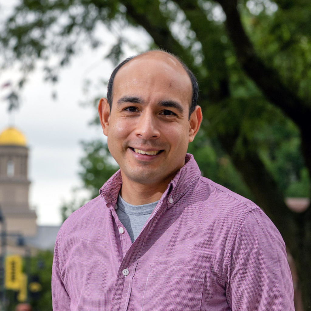 Rene Rocha Standing in front of Old Cap